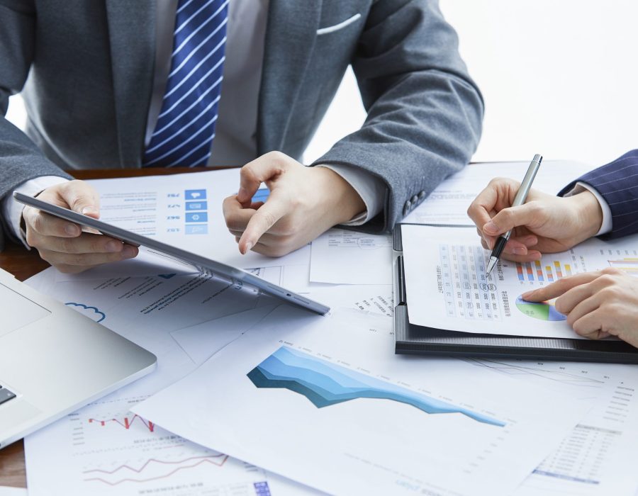 Two businessmen in elegant suits at a business meeting discussing a new project in the office